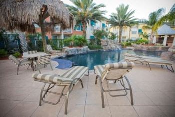 a pool with a bunch of chairs around it